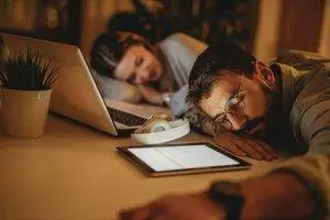 man and a woman working late