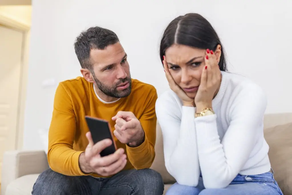 Man questioning his girlfriend about her phone searches.